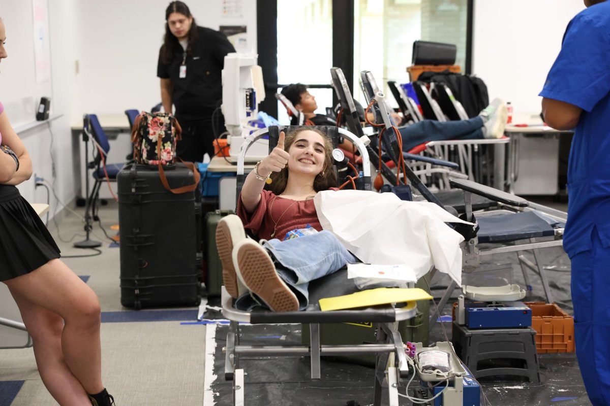 As a sure sign of confidence, senior Kaelin Eckels gives a big thumbs up in the middle of donating blood. She braved the blood drive today with two things to motivate her. I have a rare blood type, so I wanted to give that, said Eckels. Also I wanted to overcome my fear of needles. Kaelin fulfilled her goals with a smile.