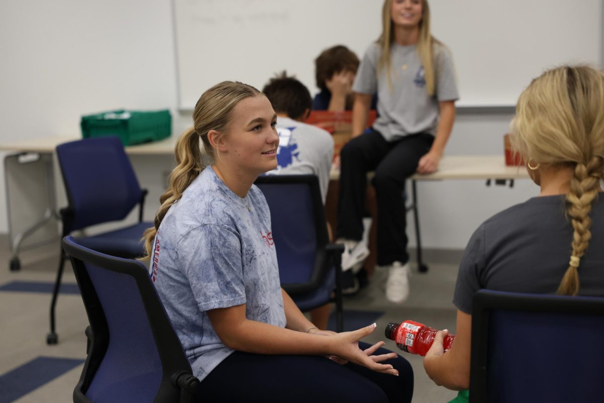 To make sure she has energy, junior Ella Scott gives Kasja Brinkerhoff a Powerade. It is important to intake liquids after donating blood to make sure the body can regain some of the fluids that were lost when drawing blood. 