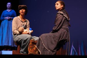 As they sit on a prop boat, sophomore Corvus Mckay and senior Kaelin Eckels perform the last scene of Anatomy of Grey. Mckay portrays the role of Homer, a character about to sail off and start a life with Eckel's character, June. "I liked playing Homer because he is so simple as a person," McKay said, "It was an outlook I have never looked at before. I loved playing a character like that."
