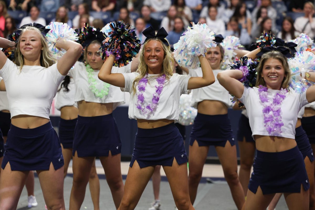 Poms in the air, senior Remi Richardson performs at the Aloha pep rallu last year. Remi originally cheered at Rock Hill. "I decided to try out for the cheer team, because my sister was going to be a senior," Richardson said. "When I was a freshman, she was on the cheer team with me."