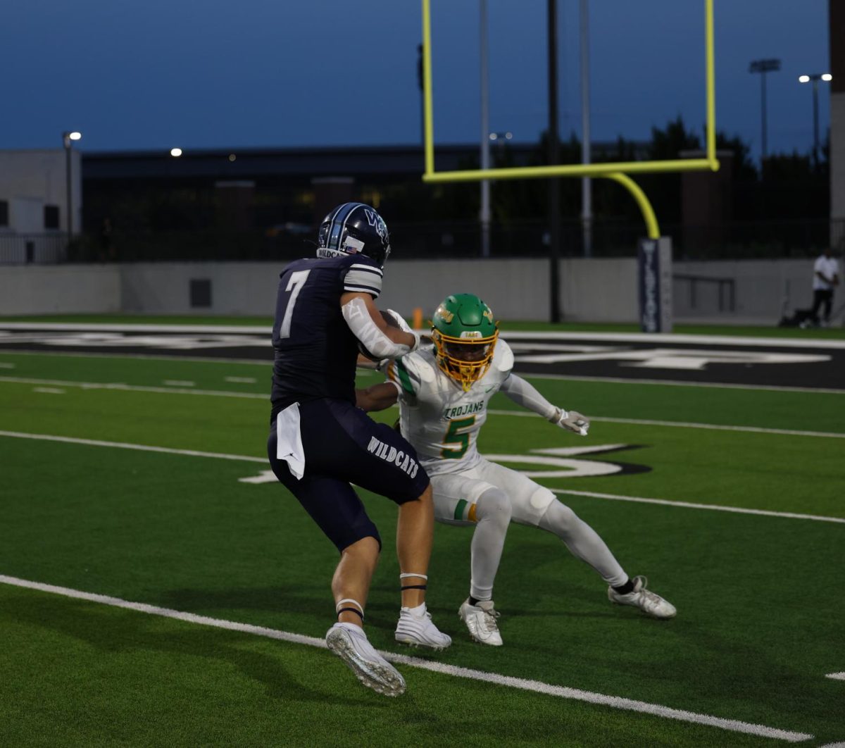 Prepared to score, No. 7 senior John Hutson jukes the opposing Trojan player. The varsity football team played against Newman Smith High School on Friday, Aug. 30. This was the first official game for the varsity football season. 