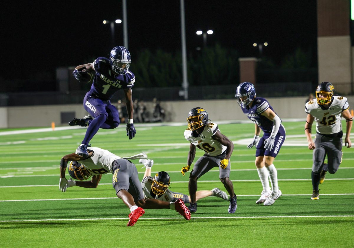 In the air, No. 1 junior Cam Newton hurdles over the opposing defender. Newton is number 1 running back in 5A district. Walnut Grove is 2nd in the 5A district ranking after the win over Denison 