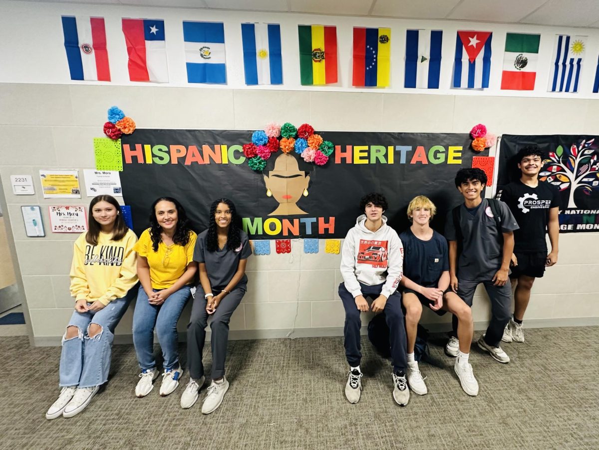 The officers pose for a picture in front of a poster made for Spanish Heritage Month, ready to start raising awareness of Spanish culture. In the picture is Gaby Mora, the Spanish Honors Society Club advisor, with her officers Andrea Gomez, Rebecca Gomez, John Reid Duran, Caleb Miller, Diego Perez-Mora, and Andre Fierro. This was taken in the language hallway in Walnut Grove High School.

