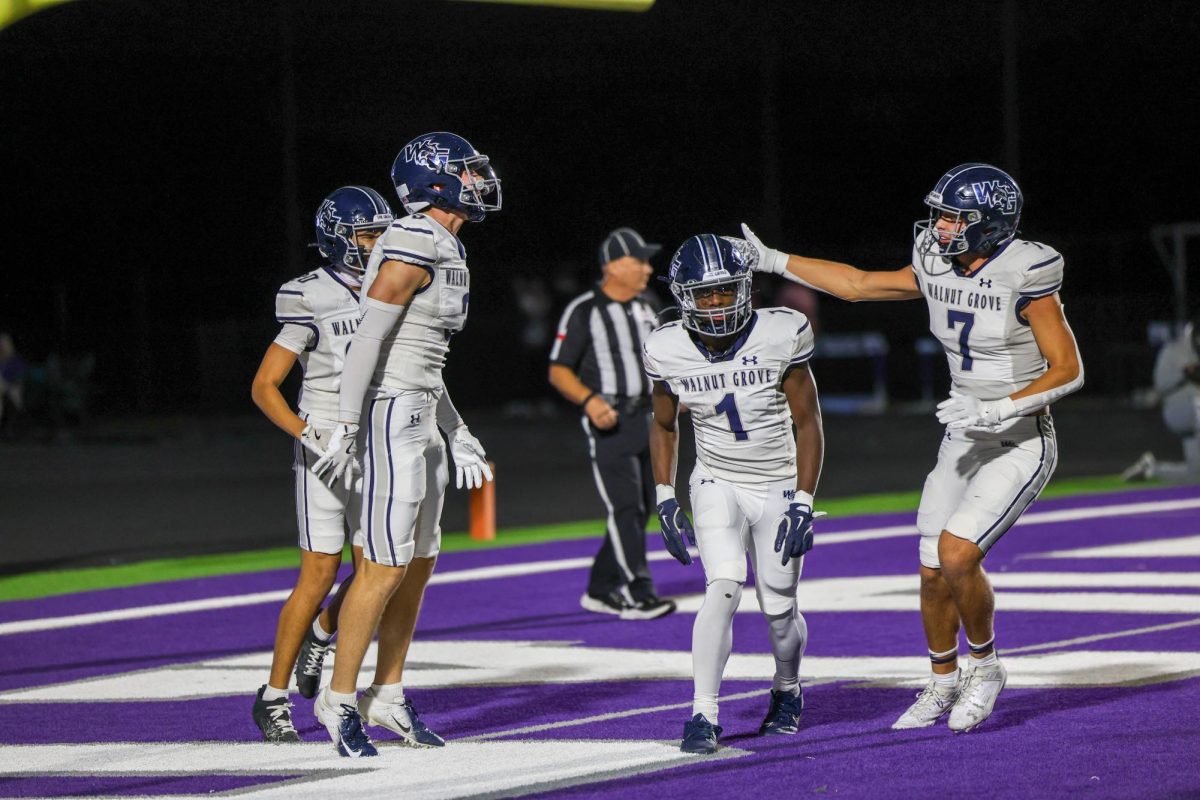 Surrounded by teammates, No. 1 junior Cameron   Newton celebrates with fellow teammates after scoring a touchdown. Newton ran for a total of 293 yards to end the game against Anna. Newton scored 3 touchdowns with 27 carries. 