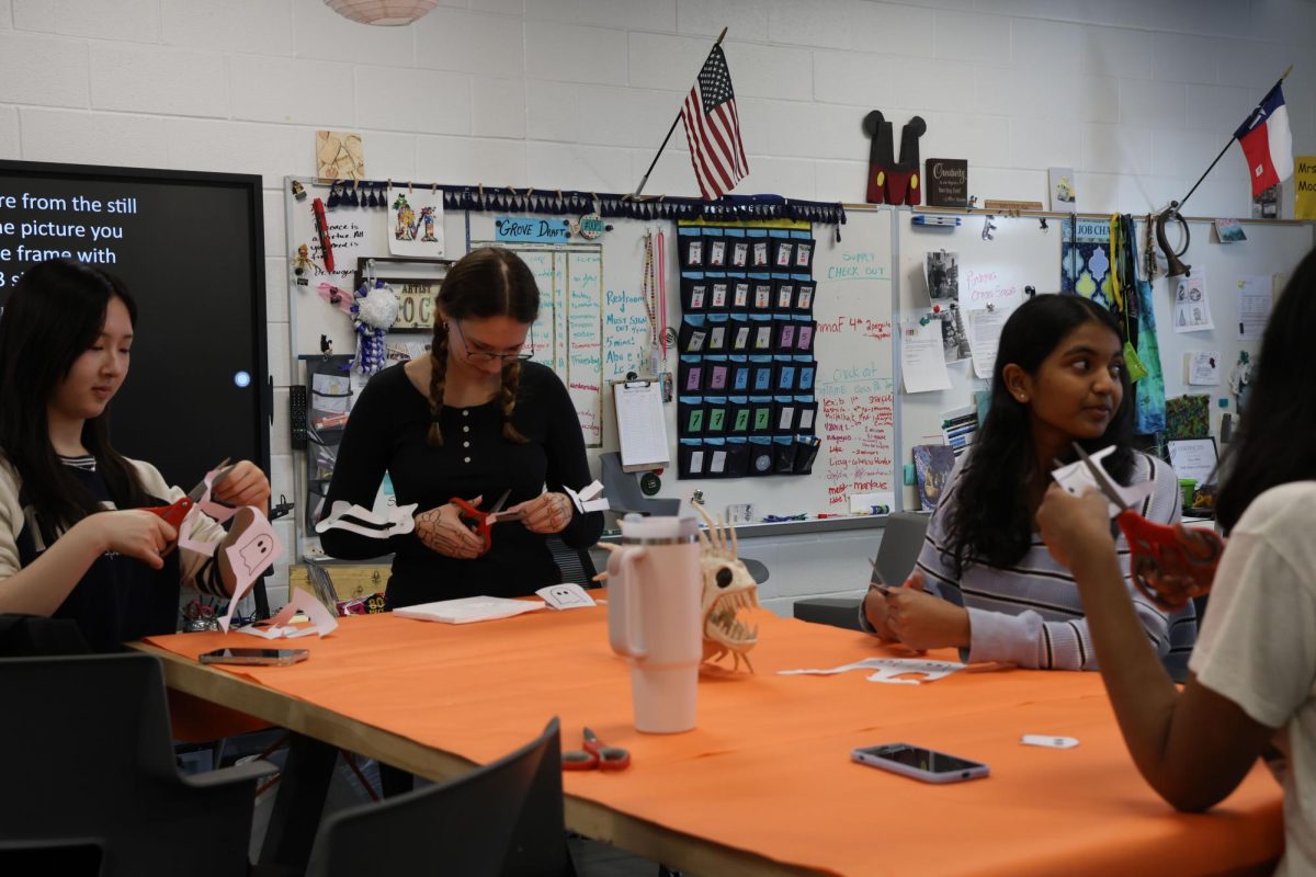 The sound of scissors fills the room as historian Jeongmin Lee and members Mya Beaty and Mrithika Kathiraven make decorations for their NAHS Halloween party. This happened on Oct. 25, and the club finished its mural and started other pieces, like a shoe painting.
