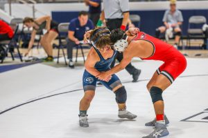 Arms around neck, junior Cole Johnson tries to gain control of his opponent. 