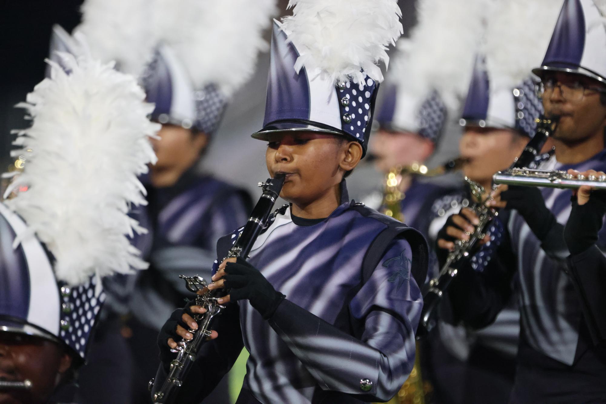 Standing on the field, junior Tanya Wesley plays the woodwind feature for the WGHS band's UIL show. This photo was taken by Q & Z productions, WGHS band photographer.