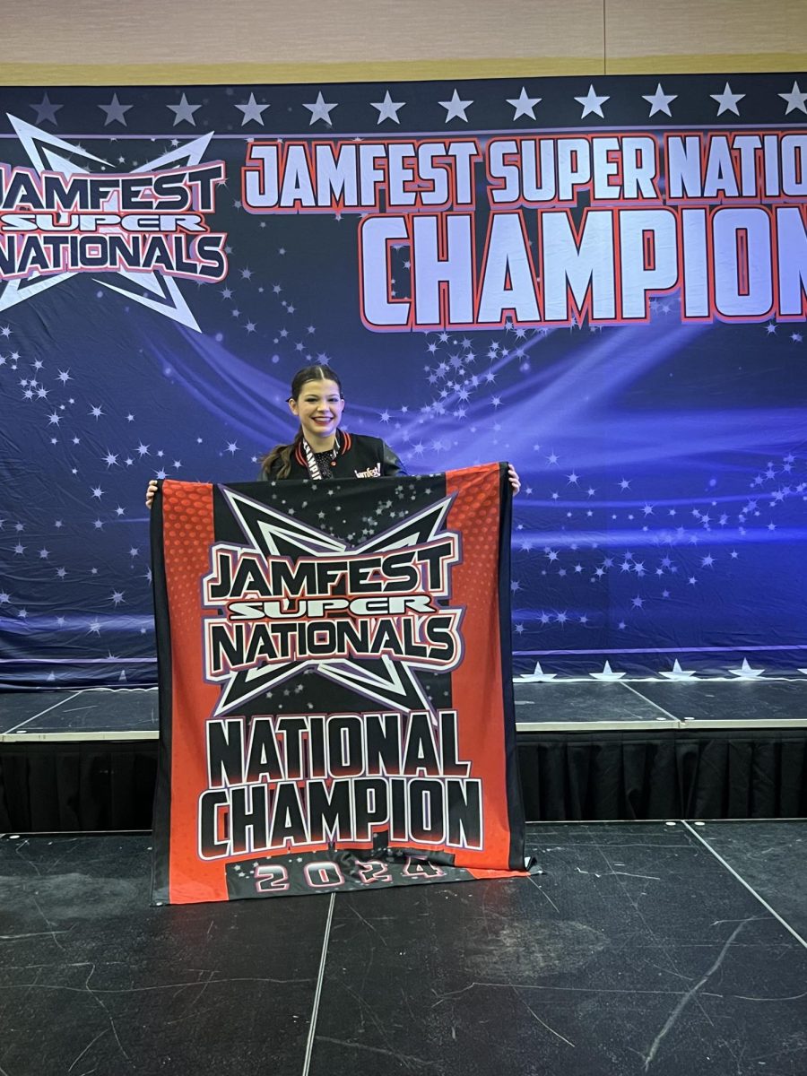 Ryan poses with her National Championship cheer award. 