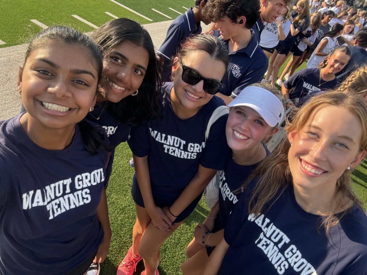 Joyful faces light up the field as Mackenzie Garcia and her friends celebrate their victory together. 