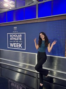 Hands in a peace sign, senior Kallie Huck poses for the camera. This picture was taken on the first media day from the WFAA student athlete scholar of the week interview. 