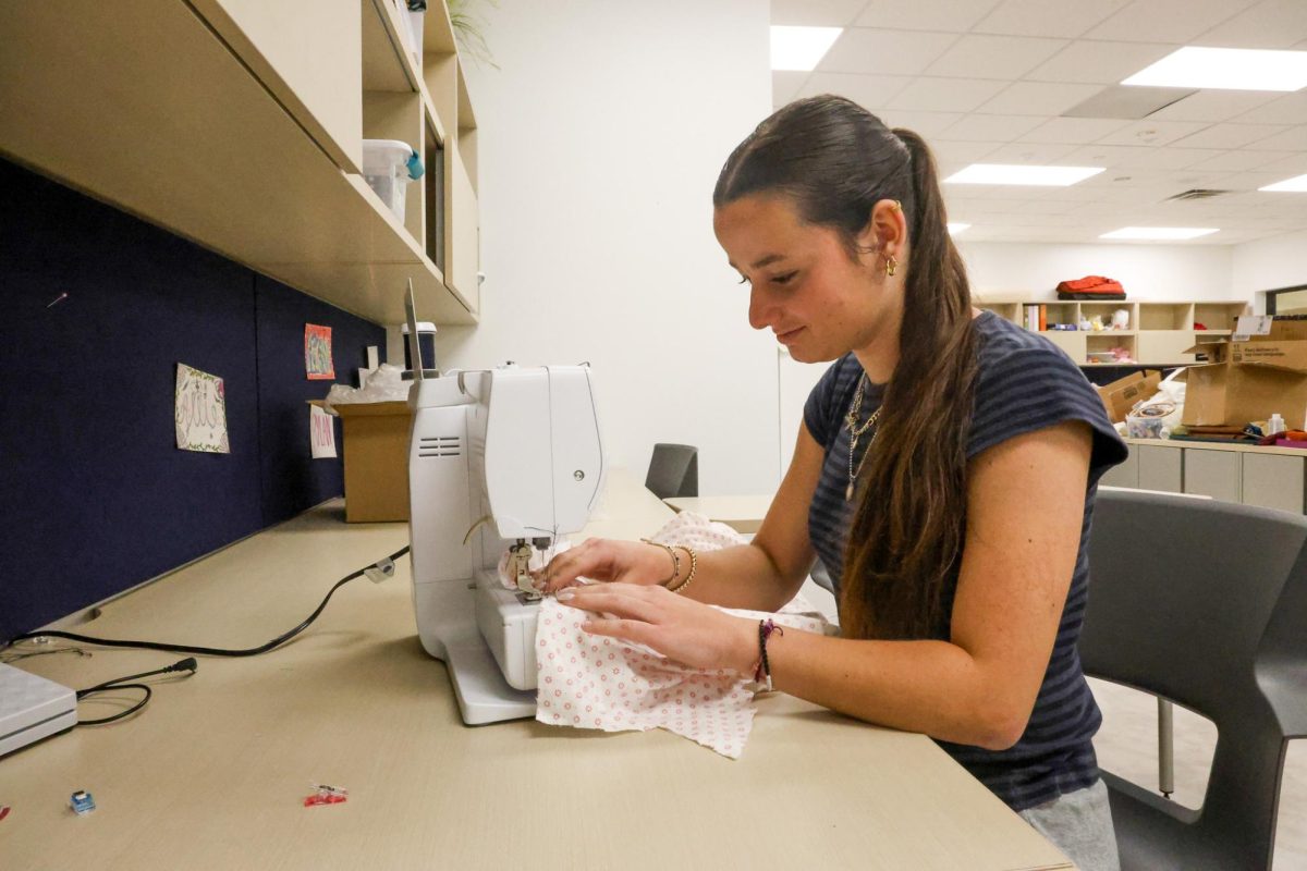 Kylie Corbridge is working on a sewing project for Fashion Design II. The fashion show just happened, and there is a lot of scrap material left over which is what Corbridge is working with right now. This photo was taken on May 6 by Abbie Fleeman.