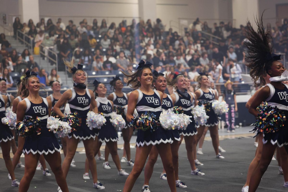 The cheer team performs at Howdy Rally.
