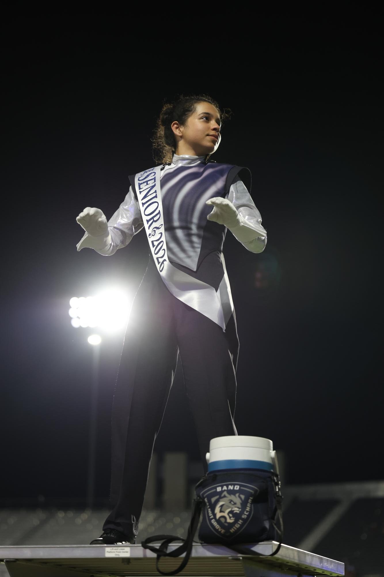 Hands poised, Senior Jeel Soni conducts the band through the fight song.