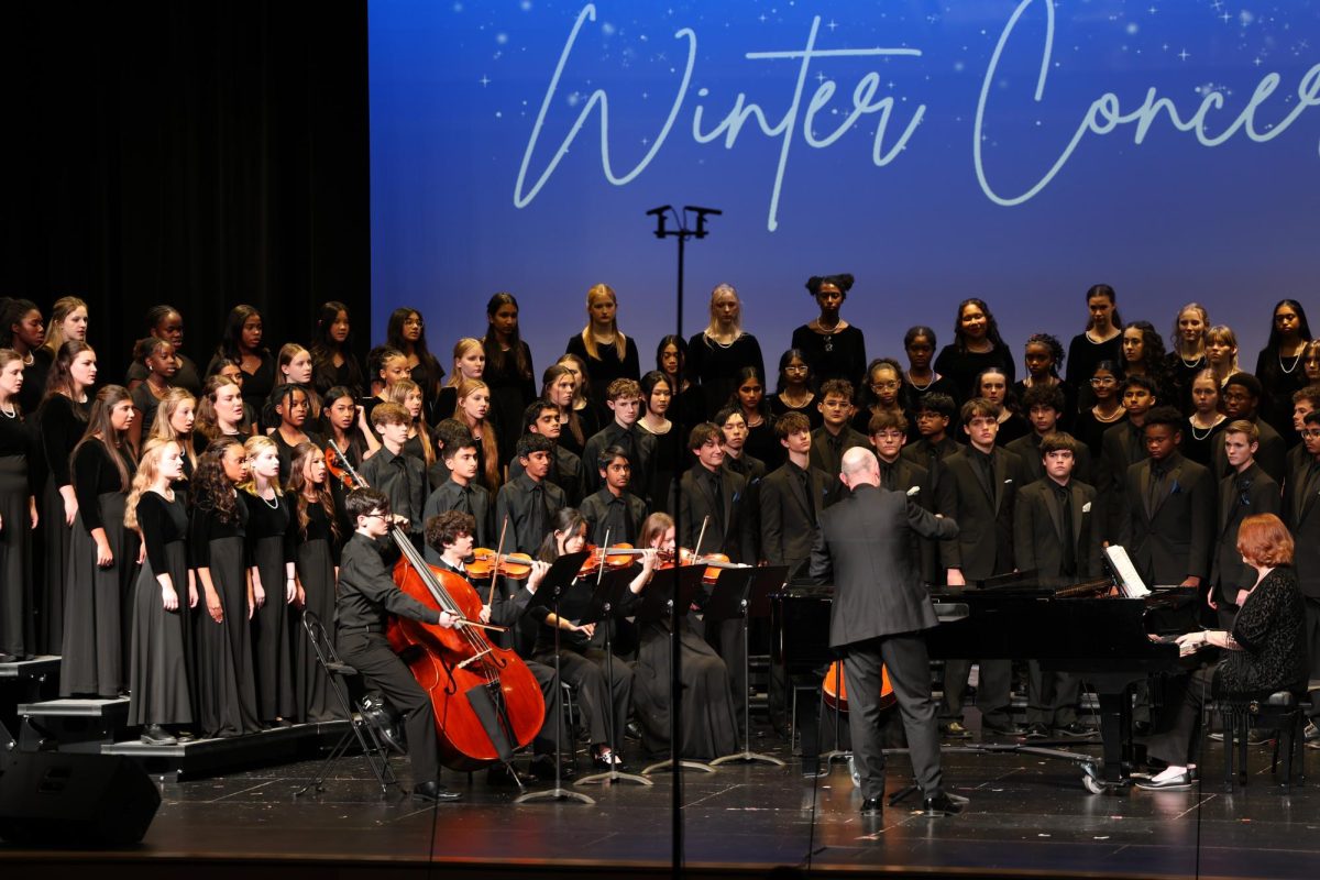 Director Eric Cooley, leads the choir ensemble through their winter concert hosted at Walnut Grove.