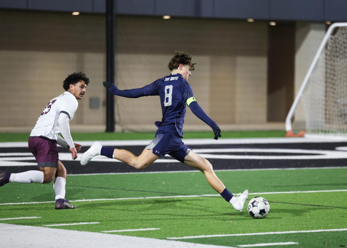 Mason Kutch sprints across the field to steal the ball away from a Sherman Highschool player on Jan. 30. Kutch attempts to score a goal.