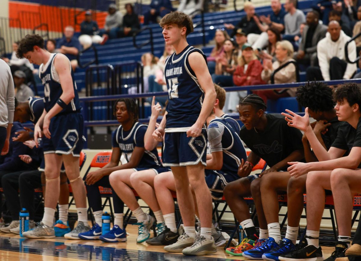 Junior Mark Anderson standing up after his teammates scored.