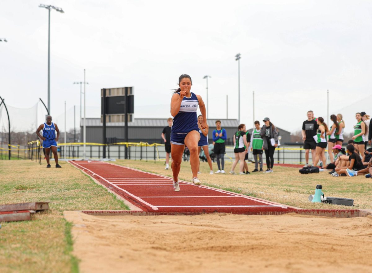 Senior Hunter Hawkins braces for impact in the long jump.