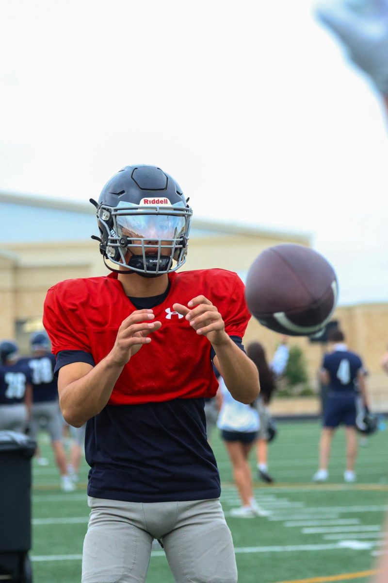 Freshman Elijah Mills receives the snap to get ready to release the ball.