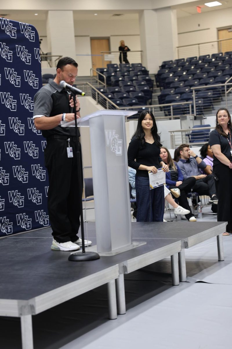 Smile painted oner face, Senior Karis Liao gracefully accepts her Excellence award at the April 24th Walnut Grove awards ceremony. 