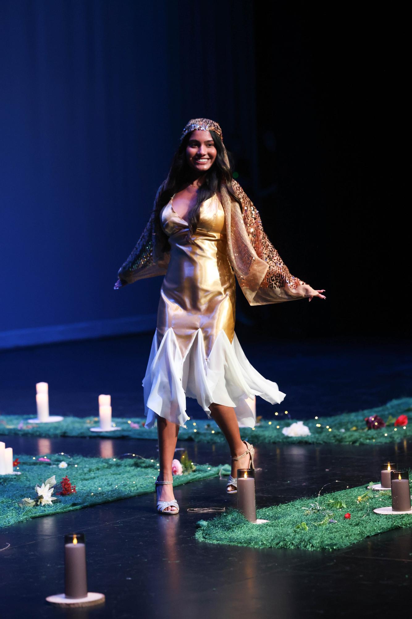 Senior Miranda Graham wore a gold dress with white flowing fabric at the bottom.