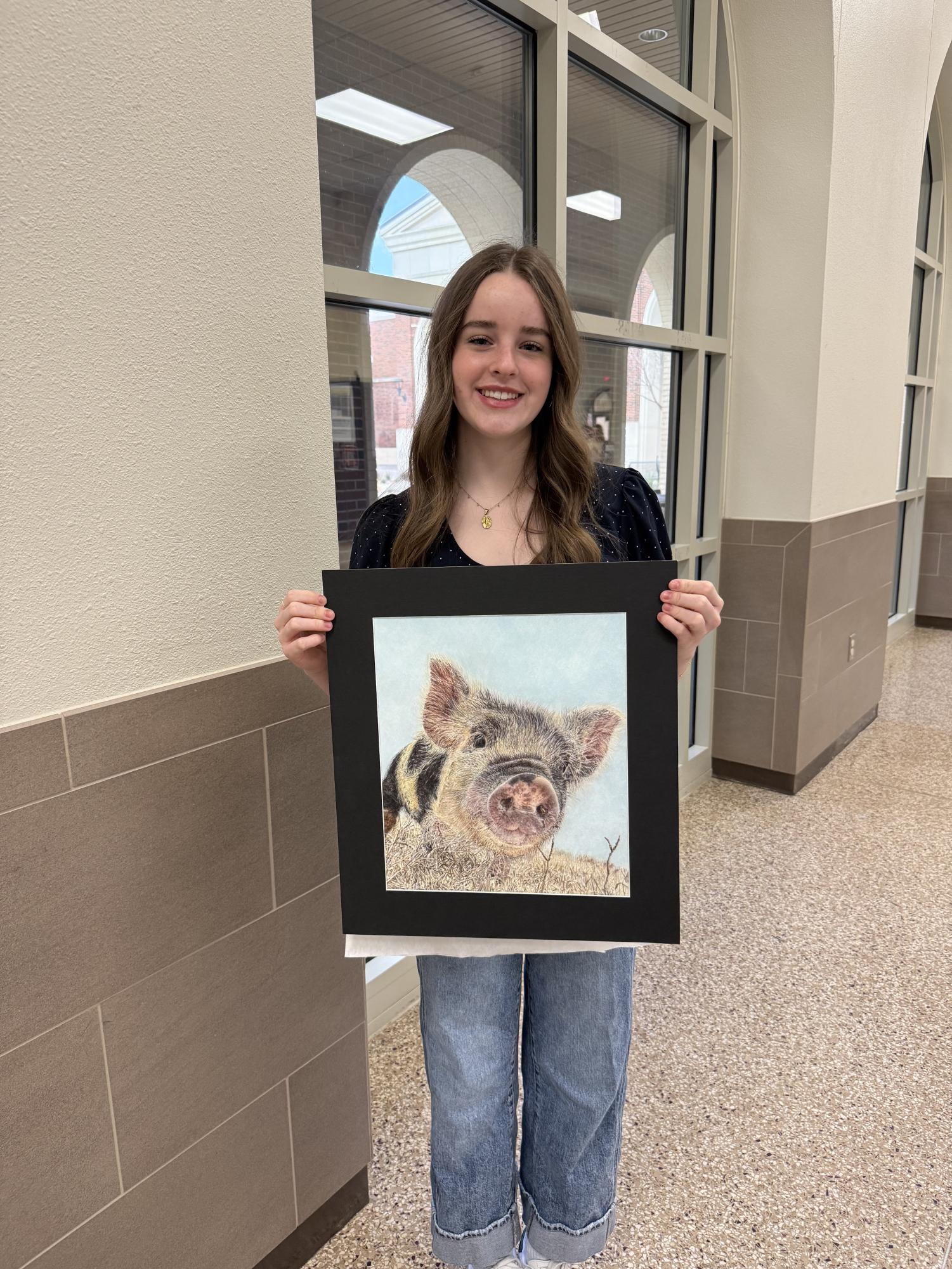 Picture of Lanning with her realism art piece. This was taken after her perfect score placement in the VASE competition. 
Courtesy of Emily Lanning